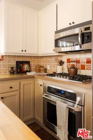 a kitchen with stainless steel appliances granite countertop a stove and a microwave