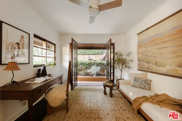 a living room with furniture a window and a flat screen tv