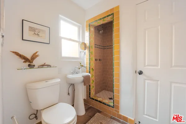 a white toilet sitting next to a bathroom sink