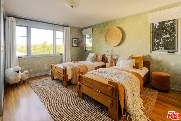 a bedroom with two beds and a window