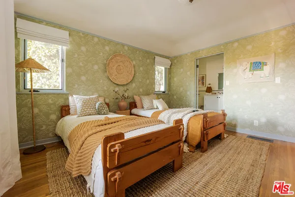 a bedroom with two beds and a window