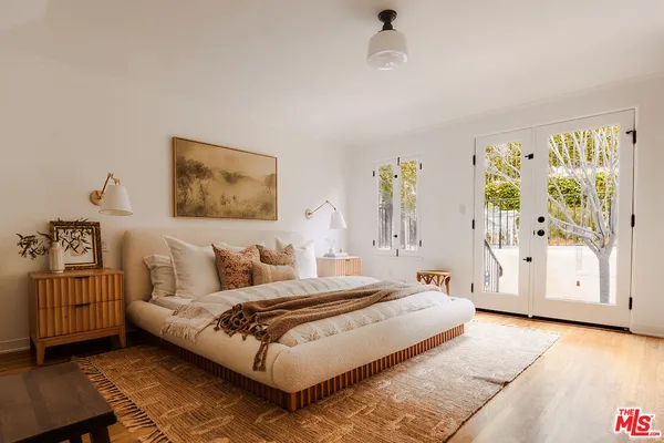 a bedroom with a large bed and a couch