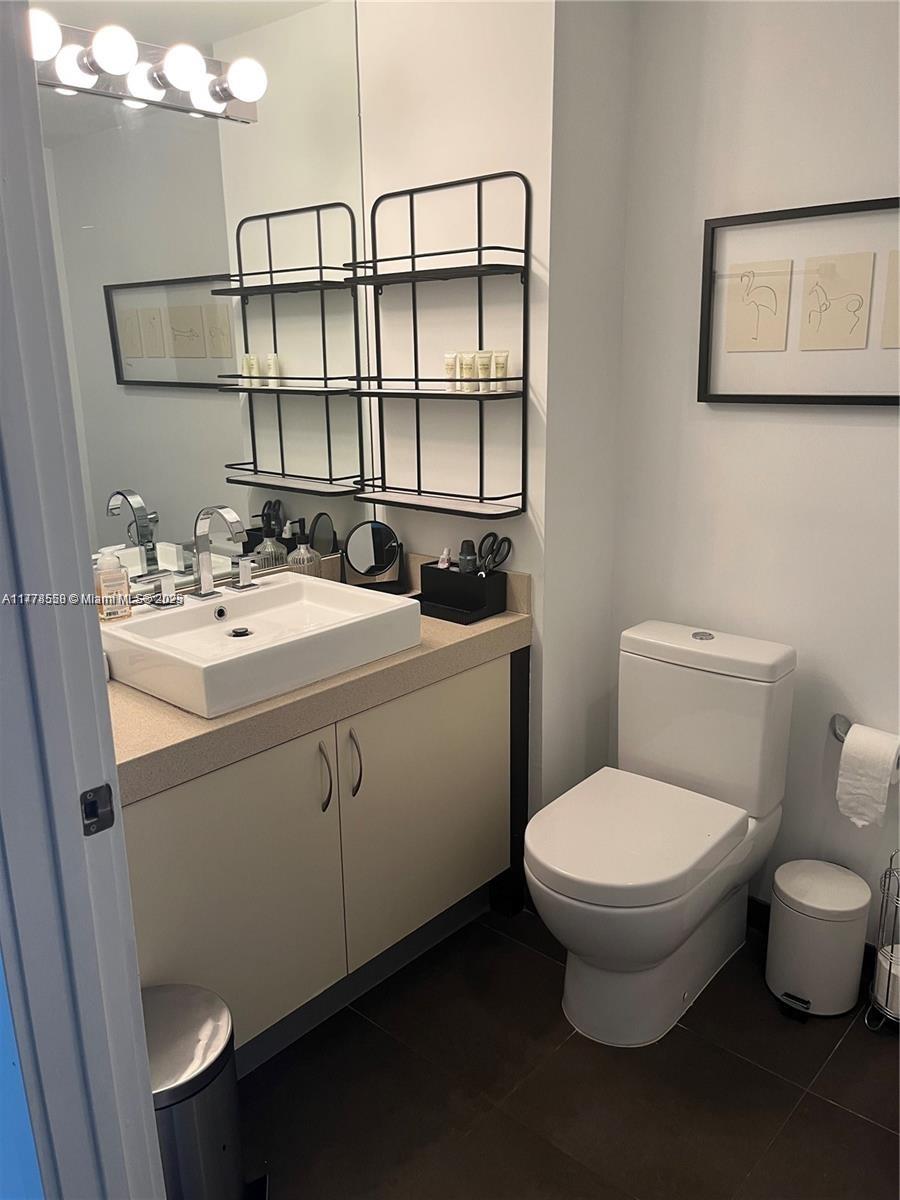 2130 Park Avenue, Unit 4 Miami Beach, FL 33139 - Photo 11 of 12 a bathroom with a toilet sink and mirror