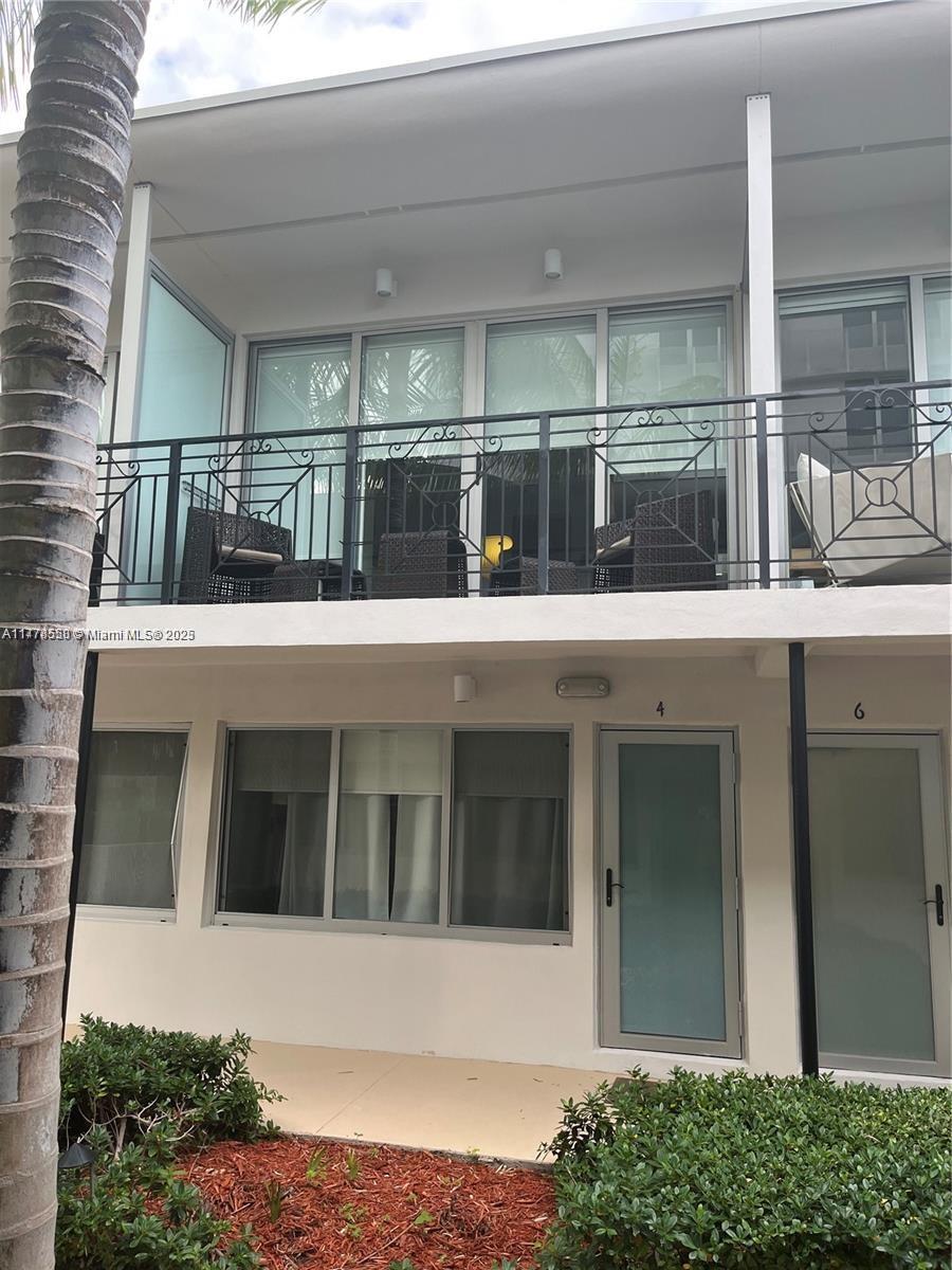 2130 Park Avenue, Unit 4 Miami Beach, FL 33139 - Photo 2 of 12 a view of a brick building next to a yard