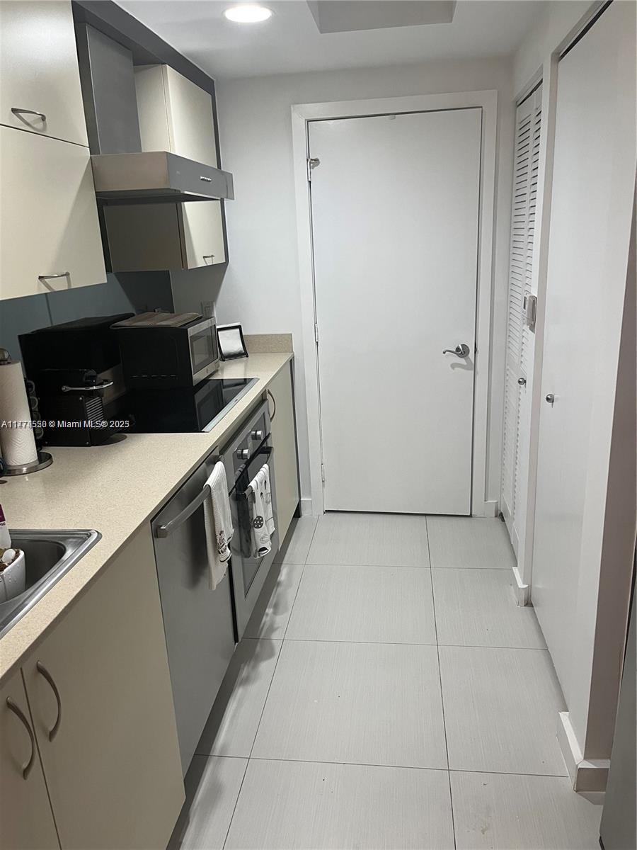 2130 Park Avenue, Unit 4 Miami Beach, FL 33139 - Photo 6 of 12 a kitchen with a sink and a stove top oven
