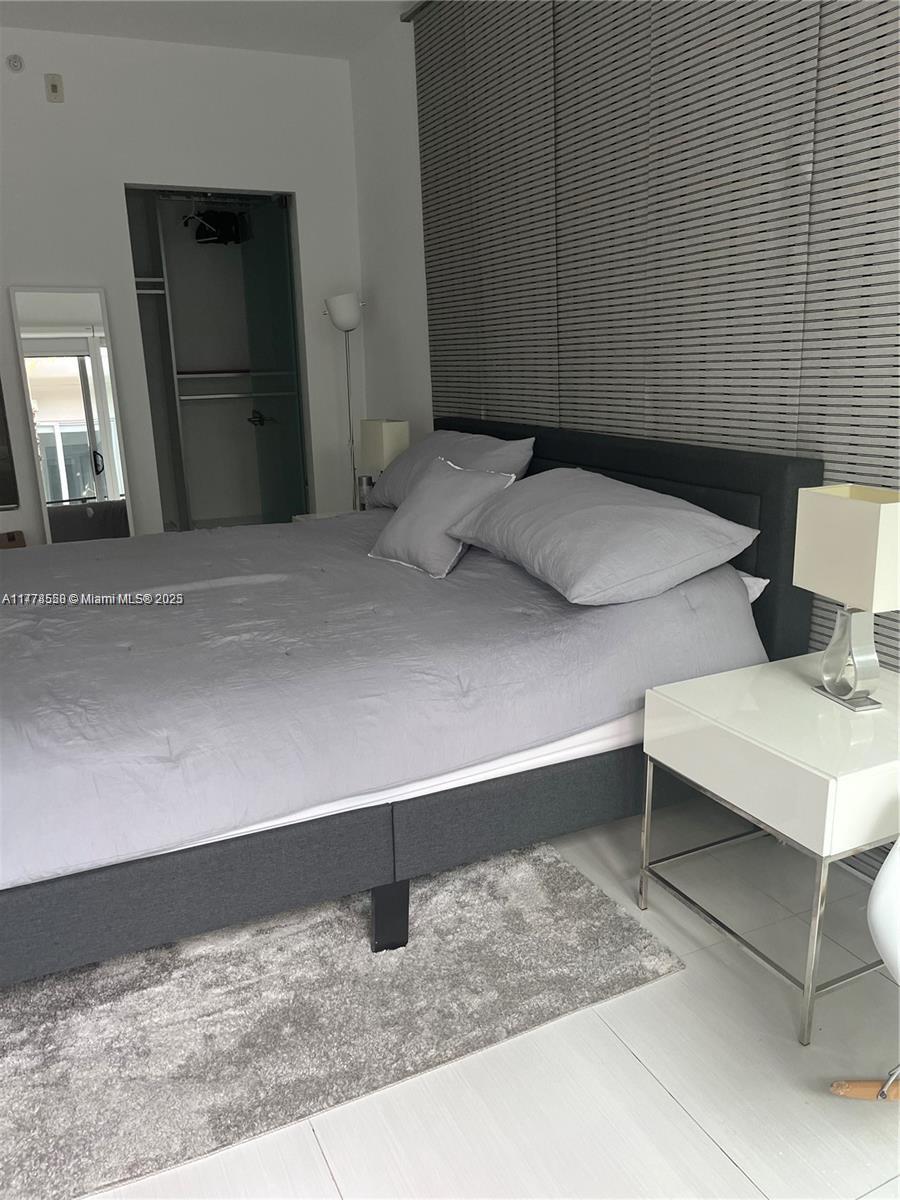 2130 Park Avenue, Unit 4 Miami Beach, FL 33139 - Photo 8 of 12 a bedroom with a bed and lamp