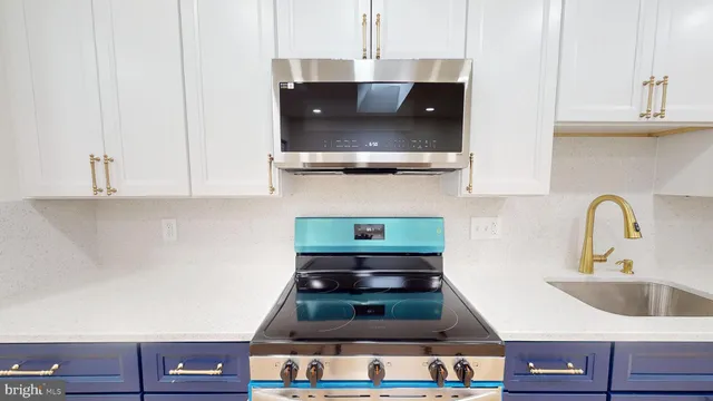 a kitchen with a stove and cabinets