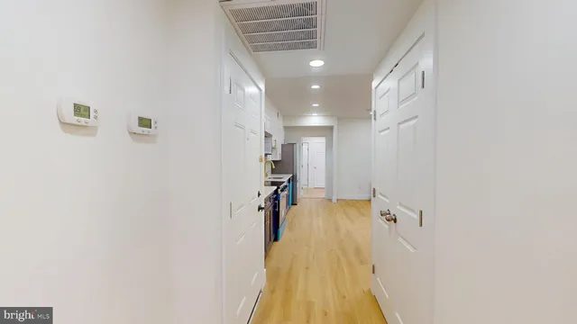 a view of a hallway with wooden floor