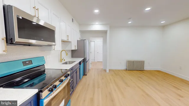 a kitchen with a sink a stove and microwave