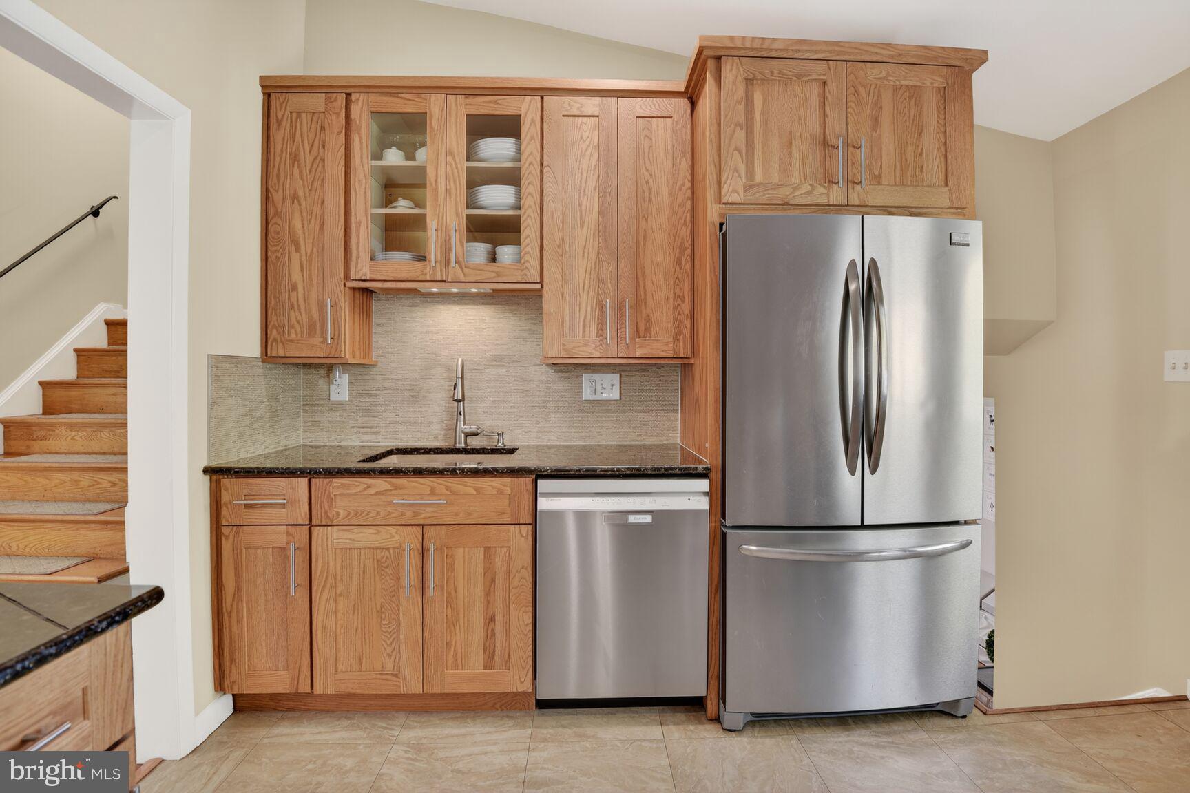 9900 Fernwood Road Bethesda, MD 20817 - Photo 12 of 39 a kitchen with stainless steel appliances granite countertop a refrigerator and a stove