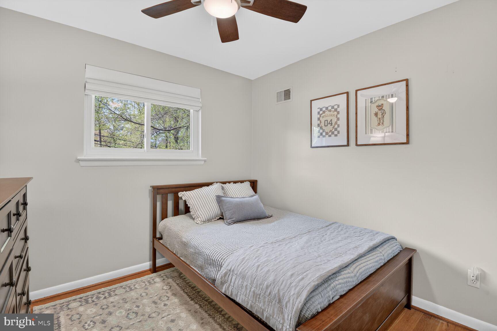 9900 Fernwood Road Bethesda, MD 20817 - Photo 25 of 39 a bedroom with bed and paintings on the wall
