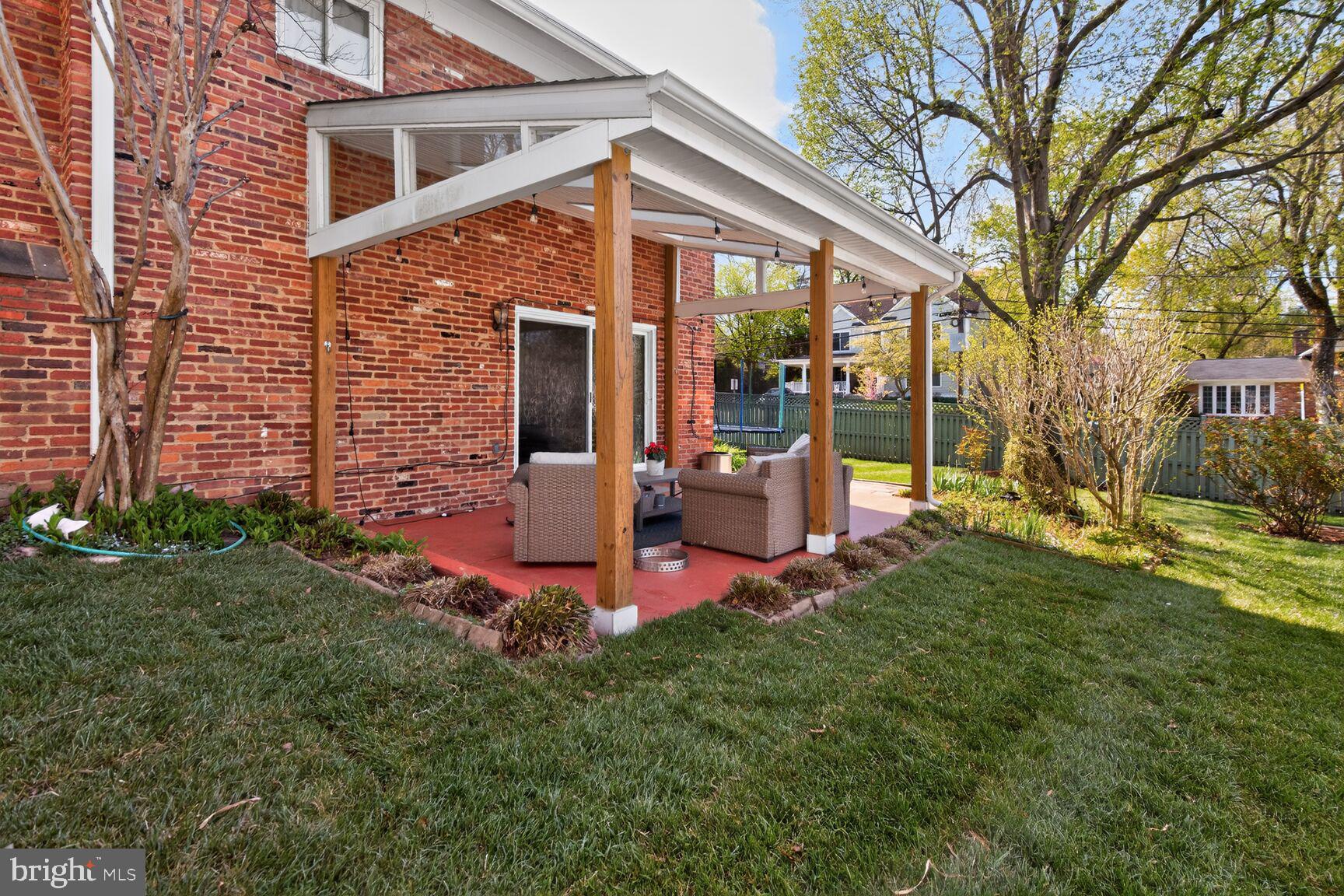 9900 Fernwood Road Bethesda, MD 20817 - Photo 31 of 39 a front view of a house with garden