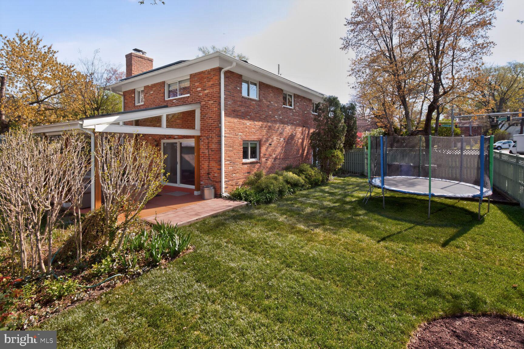 9900 Fernwood Road Bethesda, MD 20817 - Photo 32 of 39 a front view of a house with a yard