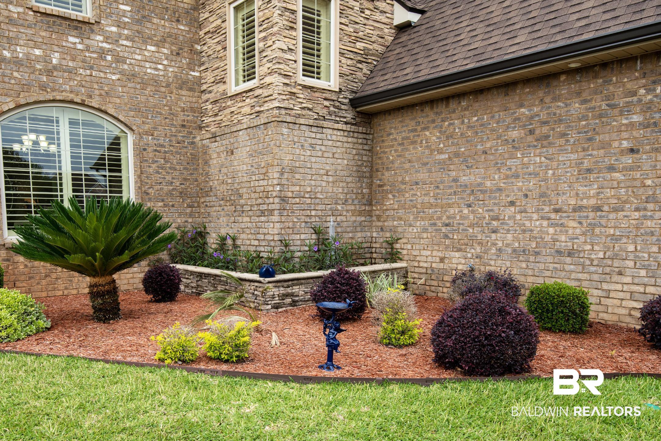 9357 Lakeview Drive Foley, AL 36535 - Photo 10 of 68 Brick exterior featuring stone accents and an arched window with interior shutters