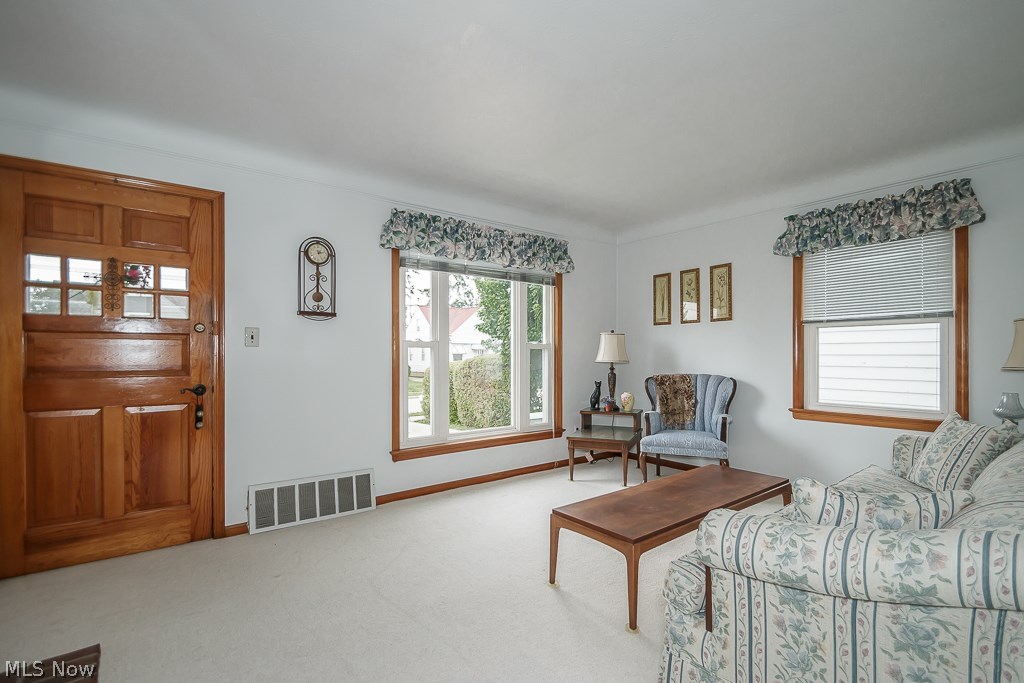 30036 Elgin Road Wickliffe, OH 44092 - Photo 4 of 21 Bright cheery living room with hardwood under the sparkling carpet!