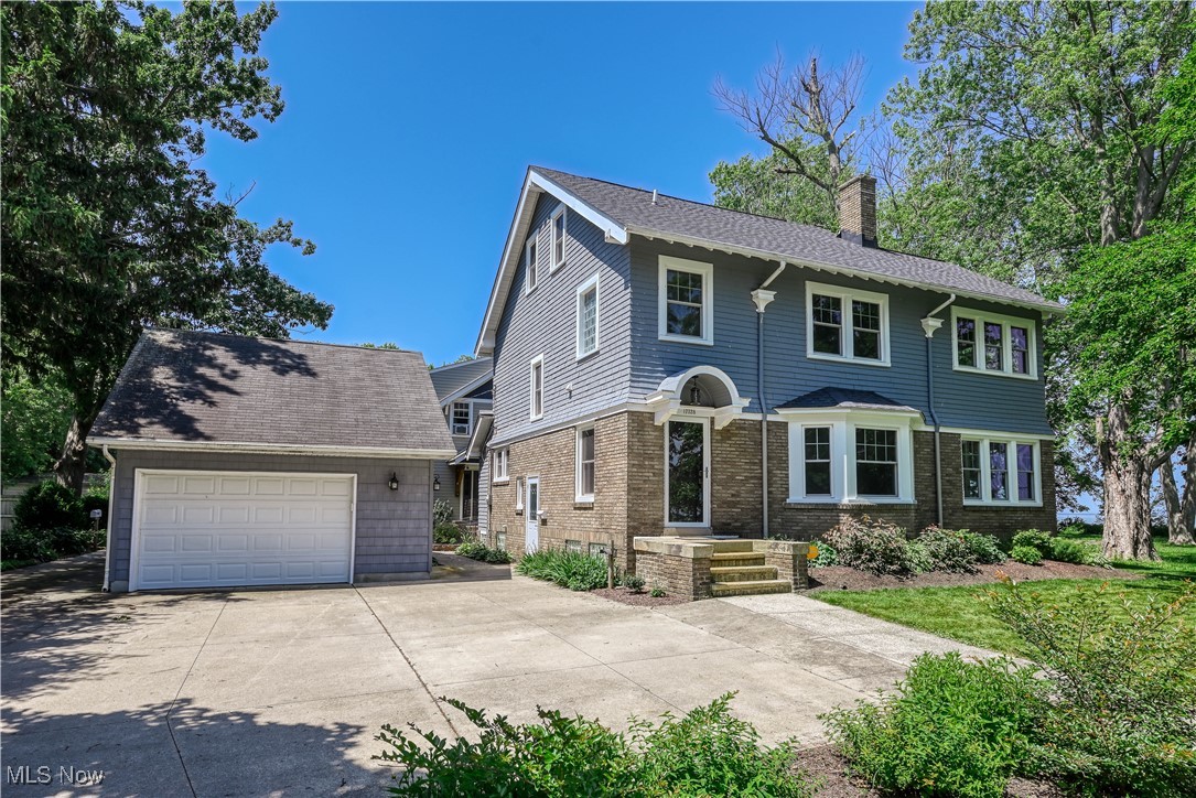 17728 Windward Road Cleveland, OH 44119 - Photo 28 of 32 View of front of house featuring a chimney, a garage, and an outdoor structure