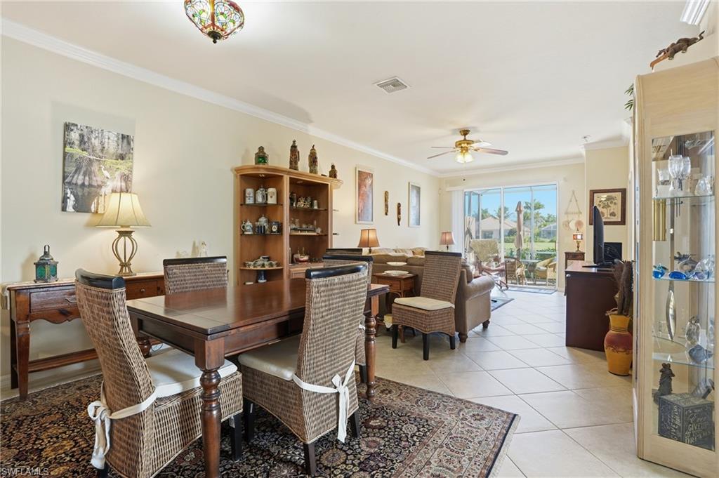 14536 Grapevine Drive Naples, FL 34114 - Photo 16 of 39 Dining room featuring ornamental molding, light tile patterned flooring, and ceiling fan