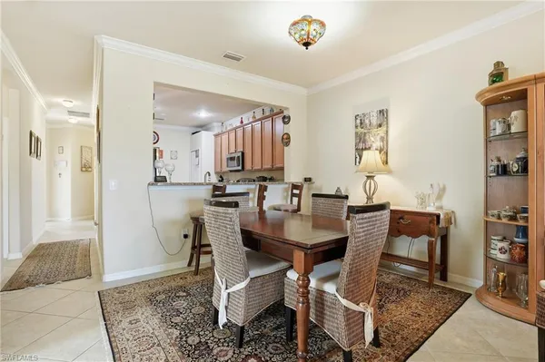 a view of a a dining room with furniture window and wooden floor
