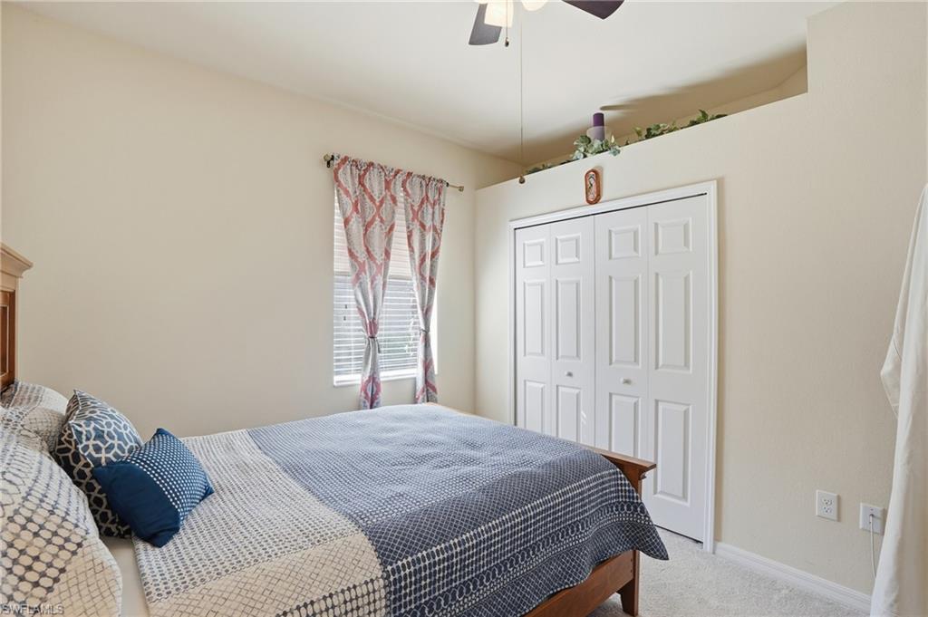 14536 Grapevine Drive Naples, FL 34114 - Photo 19 of 39 Carpeted bedroom with a closet and a ceiling fan
