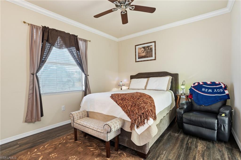 14536 Grapevine Drive Naples, FL 34114 - Photo 21 of 39 Bedroom featuring crown molding, dark wood-style flooring, and ceiling fan