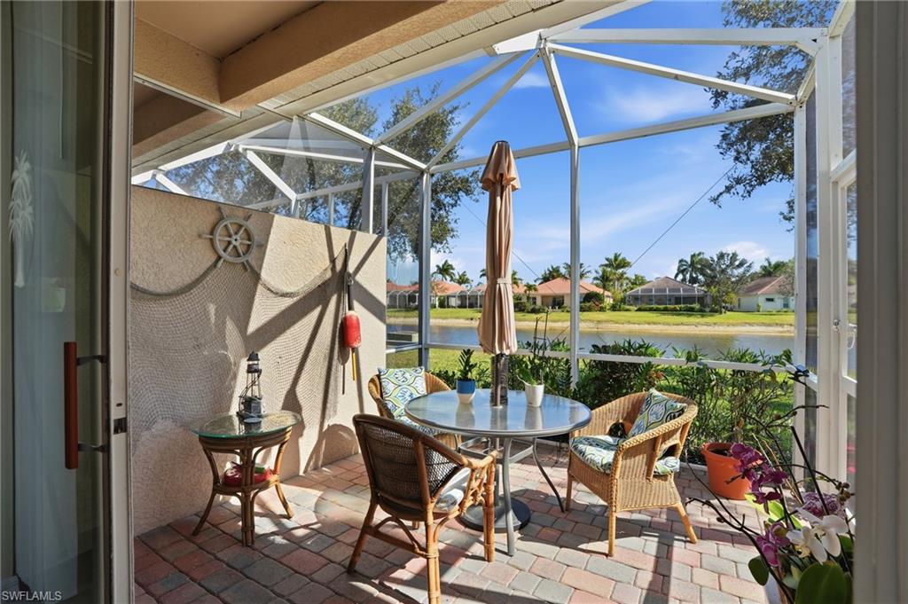 14536 Grapevine Drive Naples, FL 34114 - Photo 25 of 39 Sunroom / solarium featuring a patio, a residential view, and outdoor dining space