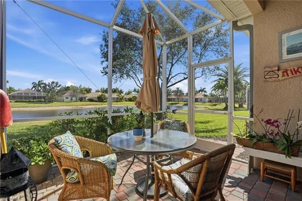 a view of a patio with couches table and chairs and potted plants