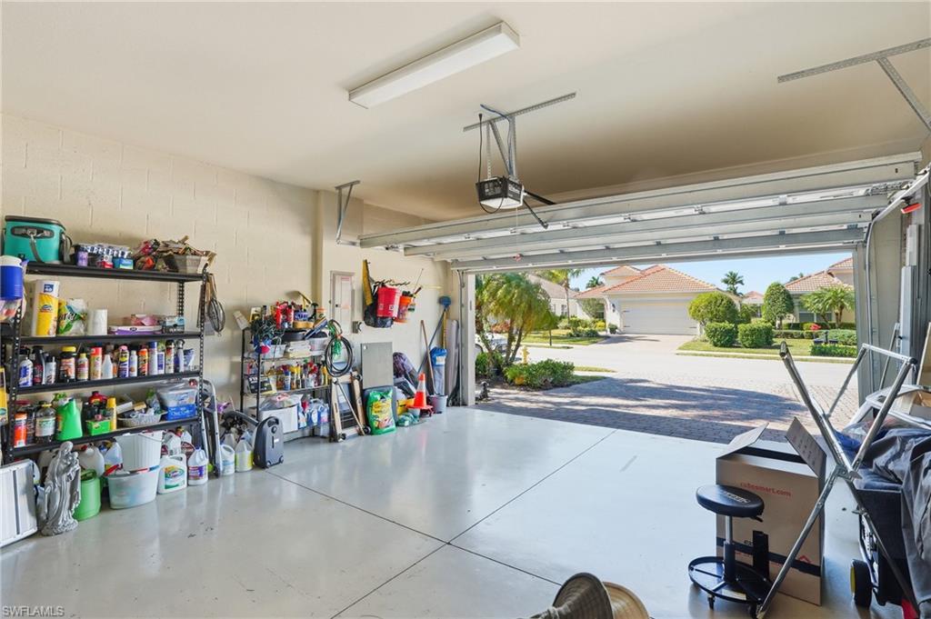 14536 Grapevine Drive Naples, FL 34114 - Photo 27 of 39 Garage featuring concrete block wall and a garage door opener