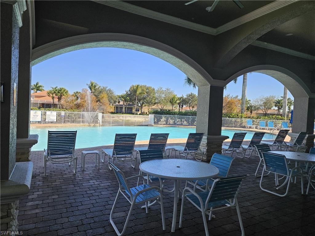 14536 Grapevine Drive Naples, FL 34114 - Photo 31 of 39 View of patio / terrace featuring ceiling fan, outdoor dining space, and a community pool