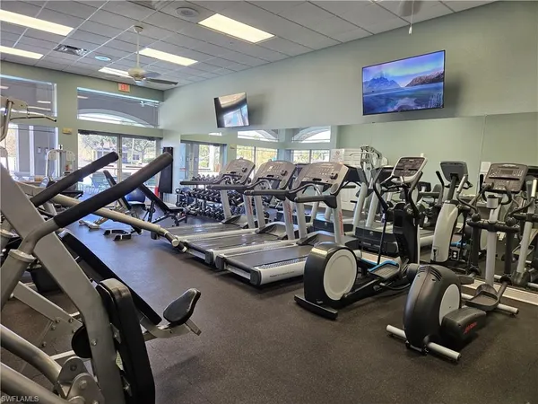 a room with gym equipment and windows