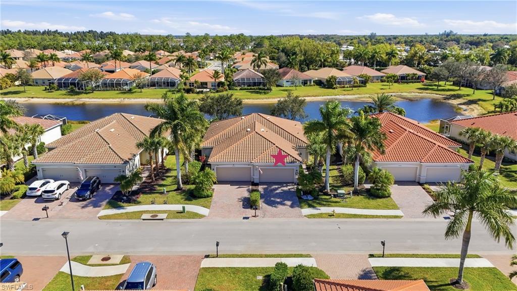 14536 Grapevine Drive Naples, FL 34114 - Photo 4 of 39 Aerial perspective of suburban area with a nearby body of water and a tree filled landscape