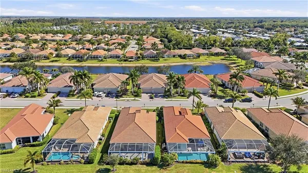 an aerial view of residential houses with outdoor space and swimming pool