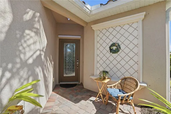 a living room with a table and a chair with wooden floor