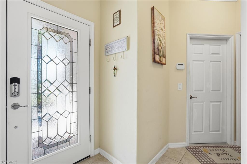 14536 Grapevine Drive Naples, FL 34114 - Photo 8 of 39 Entrance foyer with light tile patterned floors and baseboards