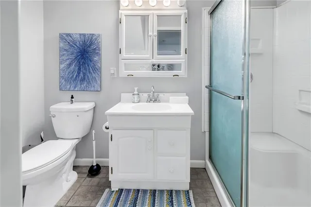 a bedroom with a large bed ceiling fan and a window