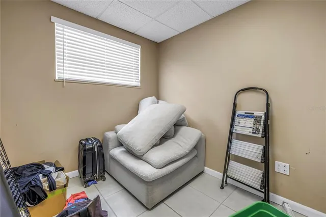 a backyard of a house with plants and large trees