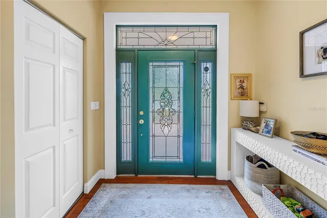 a kitchen with stainless steel appliances granite countertop a sink dishwasher a stove and a refrigerator with wooden floor