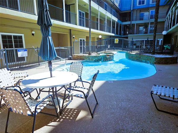 a view of a swimming pool with a lounge chairs