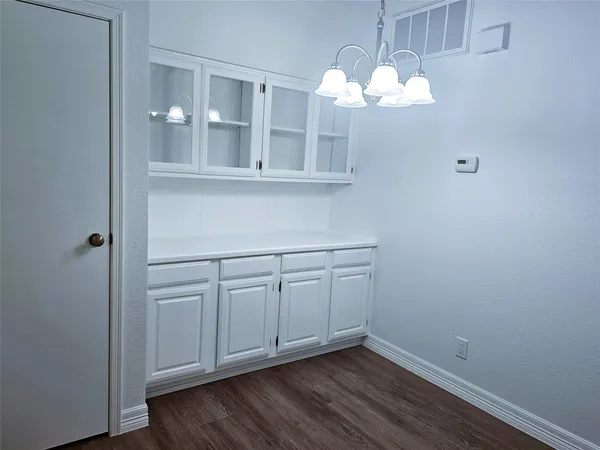 a view of cabinets and wooden floor