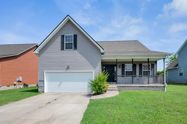 a front view of a house with a yard and garage