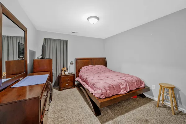 a bedroom with a bed and a large mirror