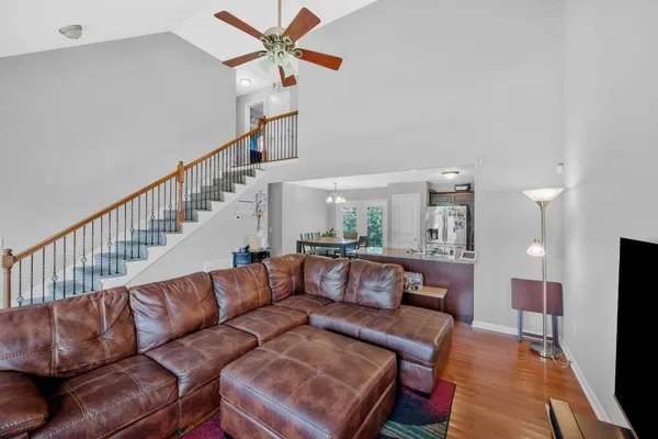 a living room with furniture and a wooden floor