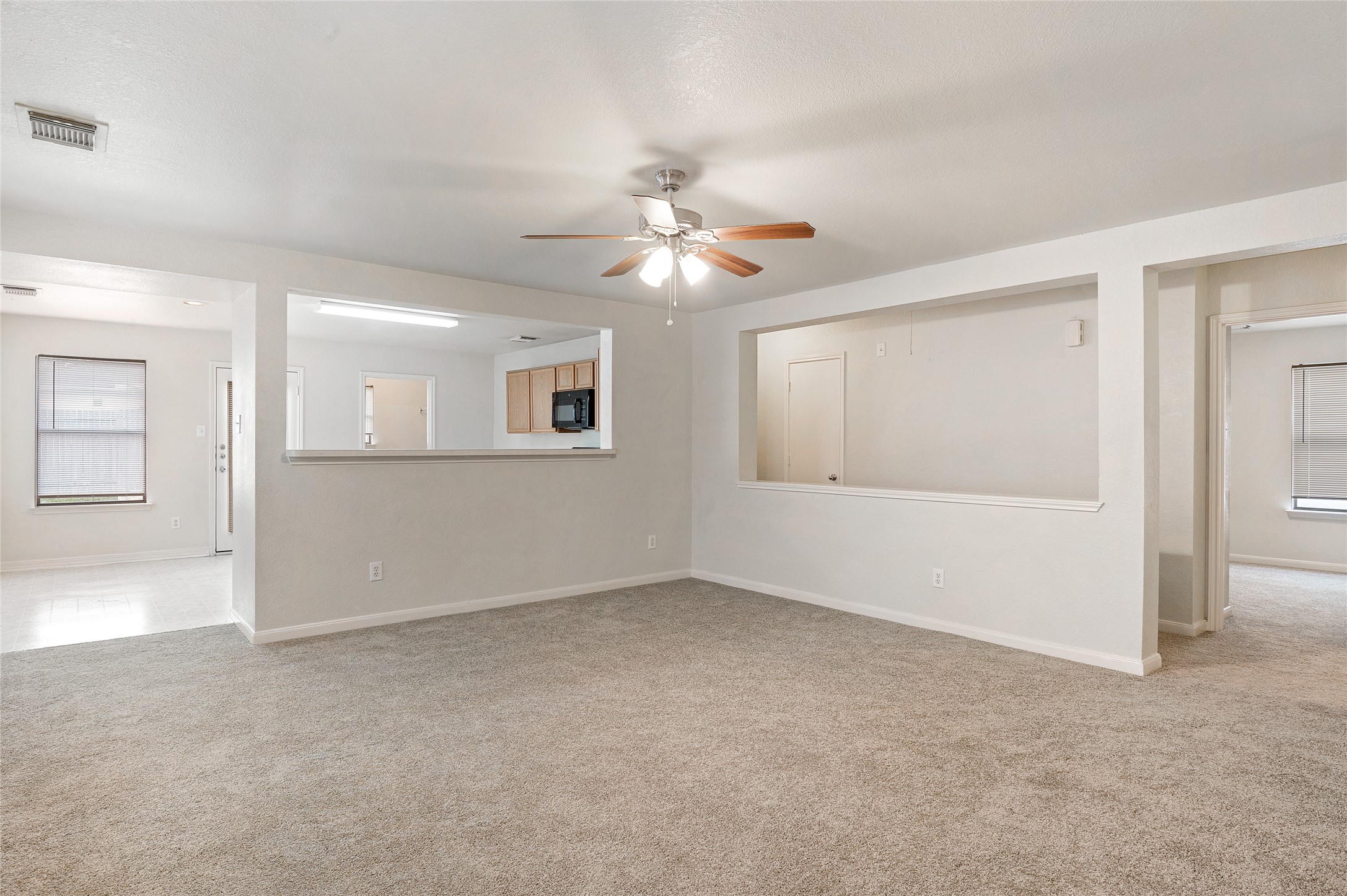 29522 Legends Stone Drive Spring, TX 77386 - Photo 3 of 17 an empty room with chandelier fan and windows