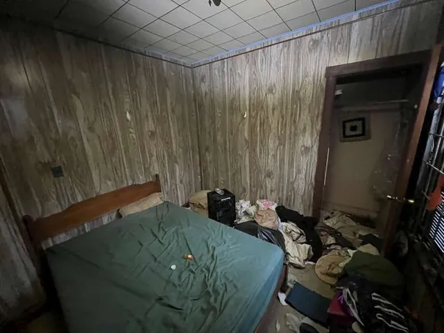 a bed room with a bed and a chair