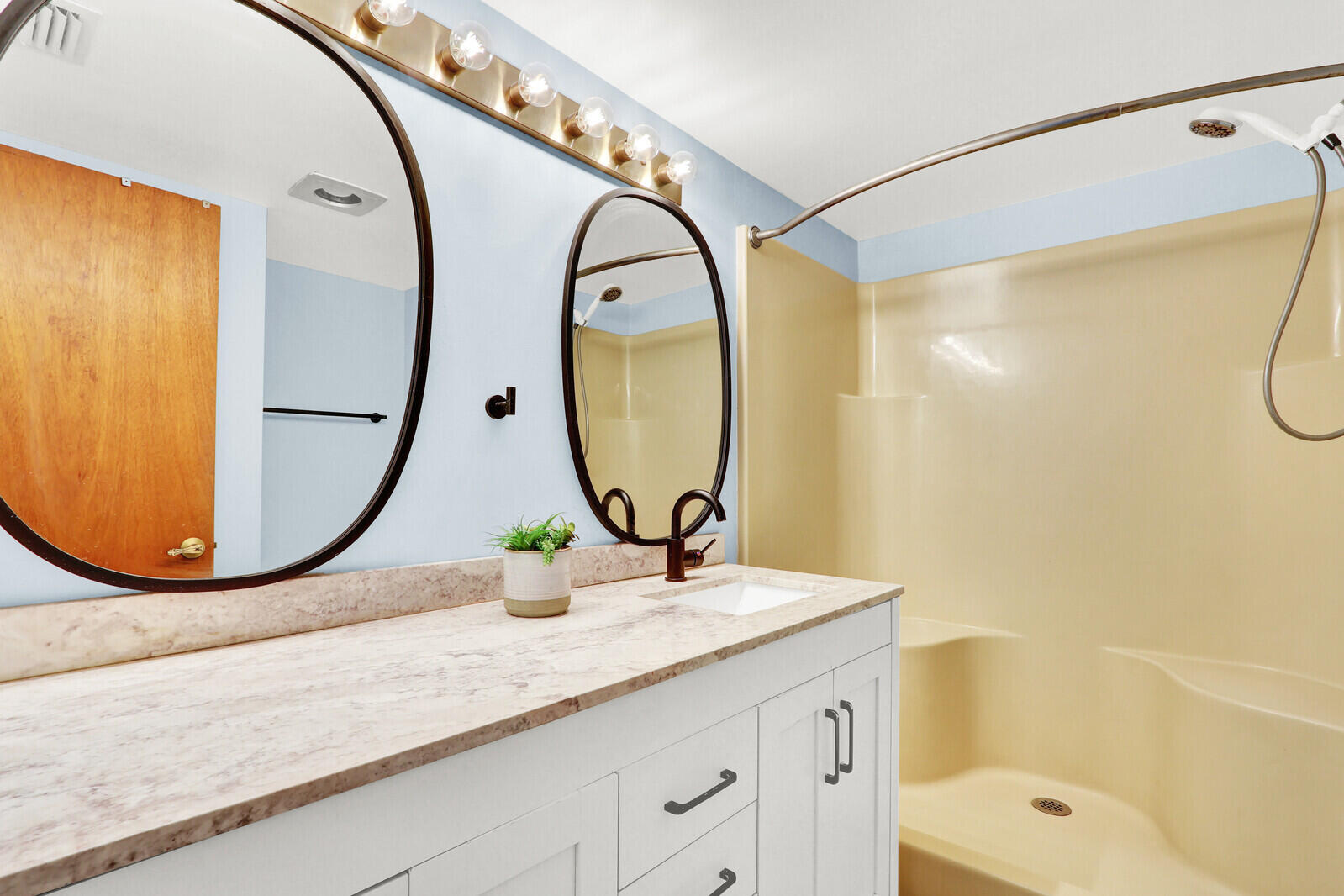 8356 Southeast Croft Circle, Unit O3 Hobe Sound, FL 33455 - Photo 11 of 20 a bathroom with a sink mirror and a bathtub