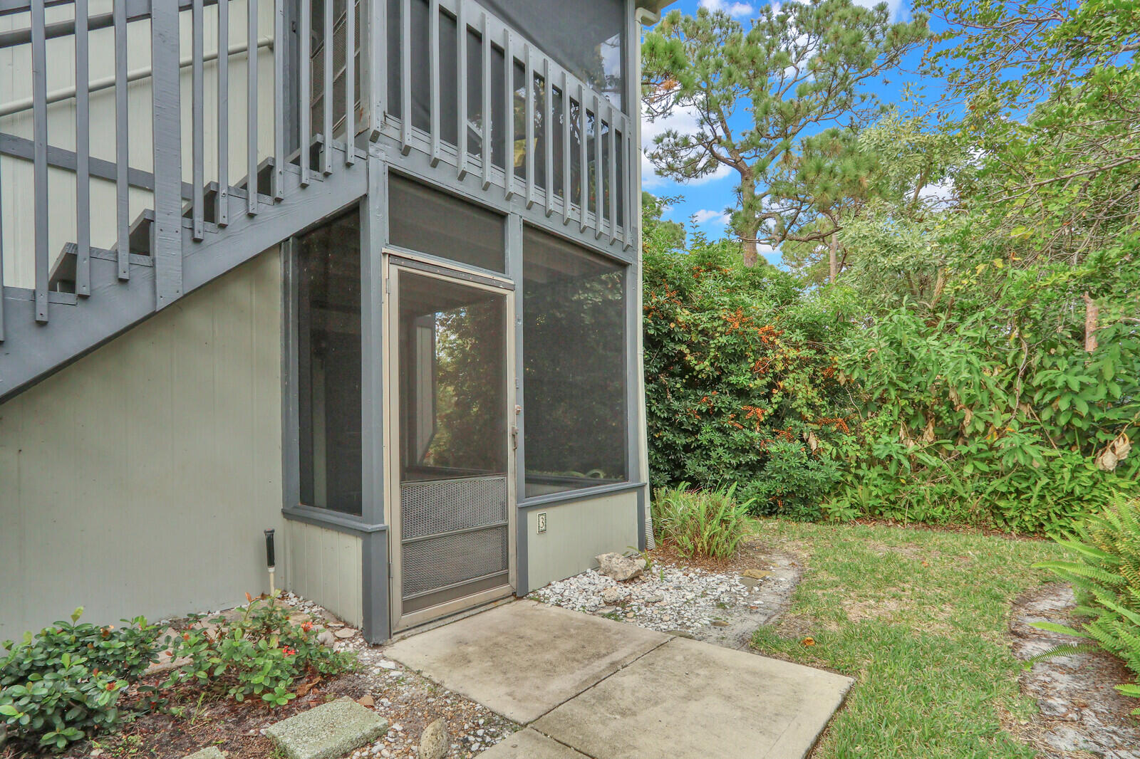 8356 Southeast Croft Circle, Unit O3 Hobe Sound, FL 33455 - Photo 16 of 20 a view of a house with a tree
