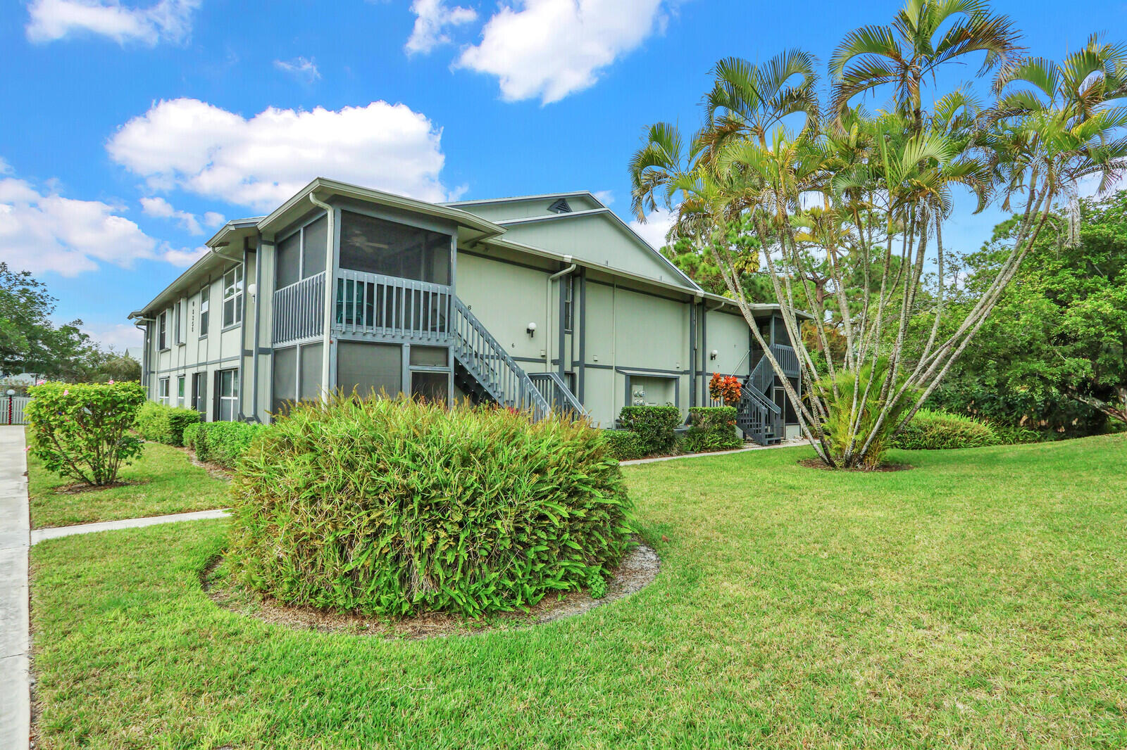 8356 Southeast Croft Circle, Unit O3 Hobe Sound, FL 33455 - Photo 20 of 20 a front view of a house with garden
