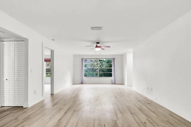 wooden floor in an empty room with a window