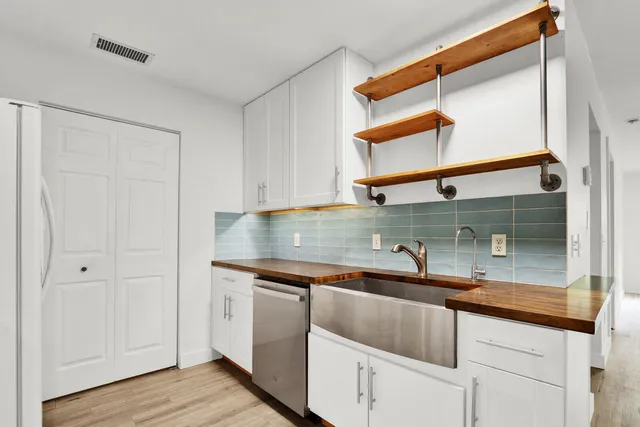 a kitchen with stainless steel appliances granite countertop a sink and a cabinets