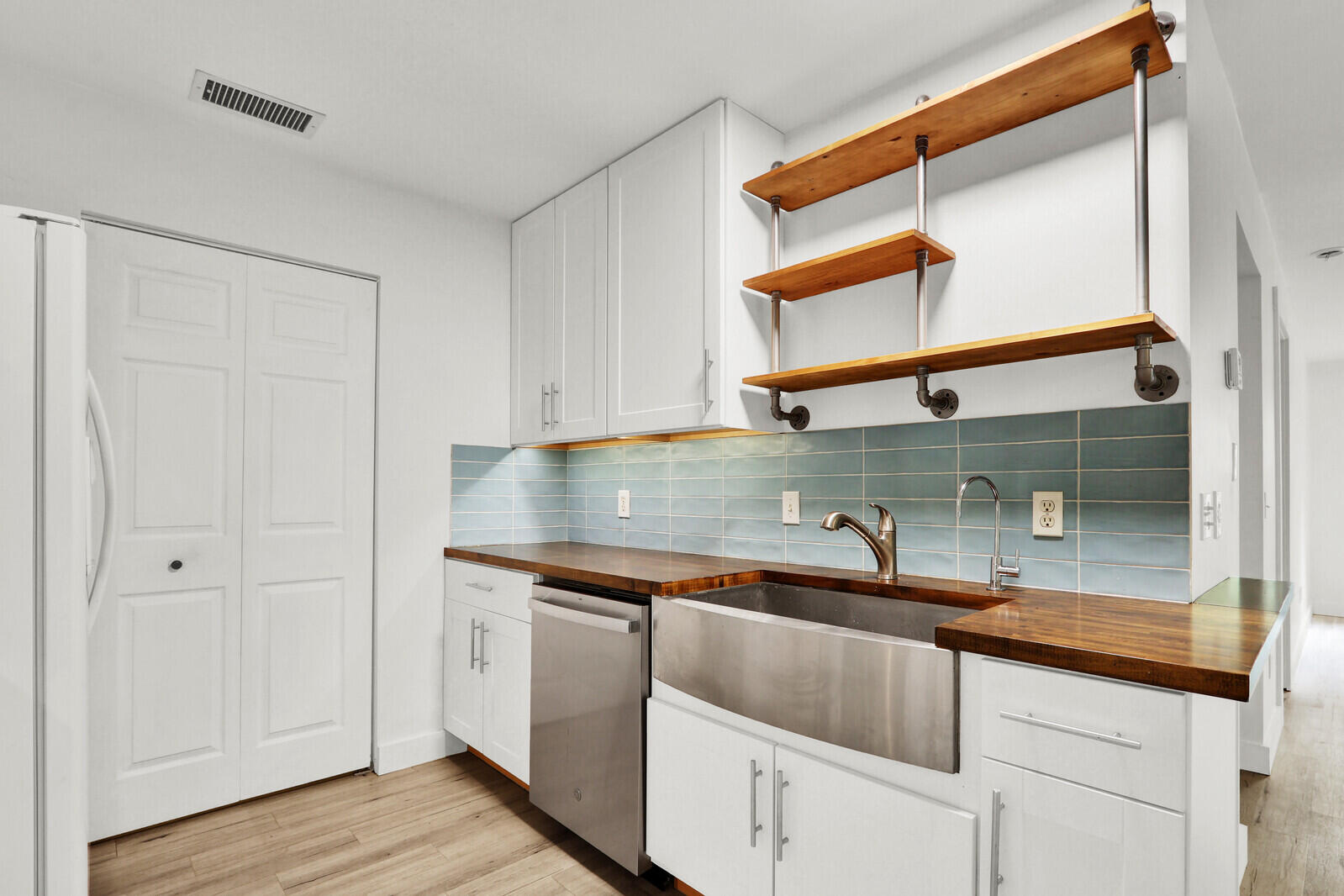 8356 Southeast Croft Circle, Unit O3 Hobe Sound, FL 33455 - Photo 7 of 20 a kitchen with stainless steel appliances granite countertop a sink and a cabinets