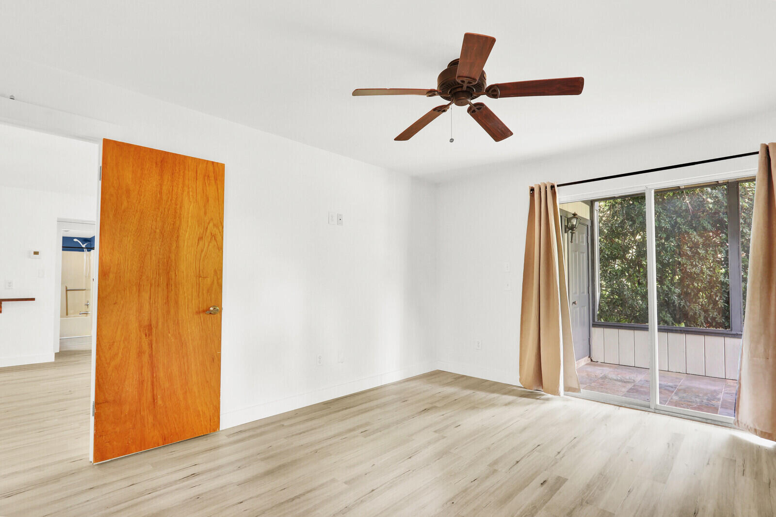 8356 Southeast Croft Circle, Unit O3 Hobe Sound, FL 33455 - Photo 10 of 20 a view of empty room with wooden floor and window